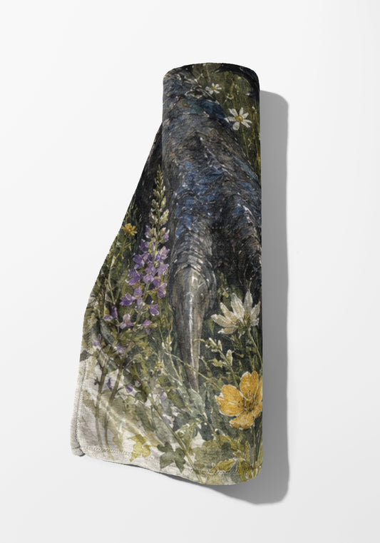 Rolled fabric with a dark floral and botanical print on a white background.