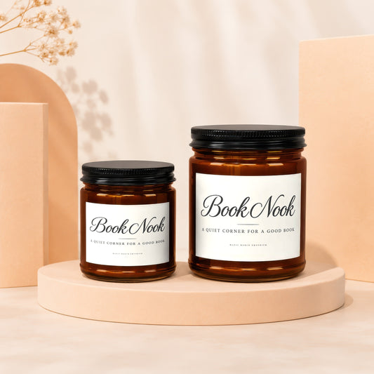 Two Book Nook candles in amber glass jars with white labels.