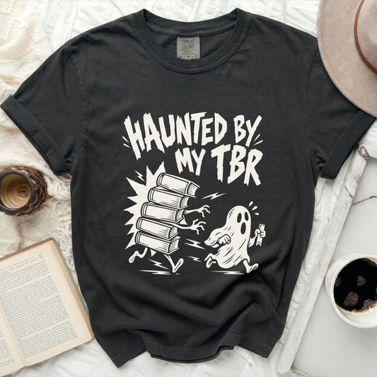 Black t-shirt with "Haunted by my TBR" graphic featuring a ghost chasing books.