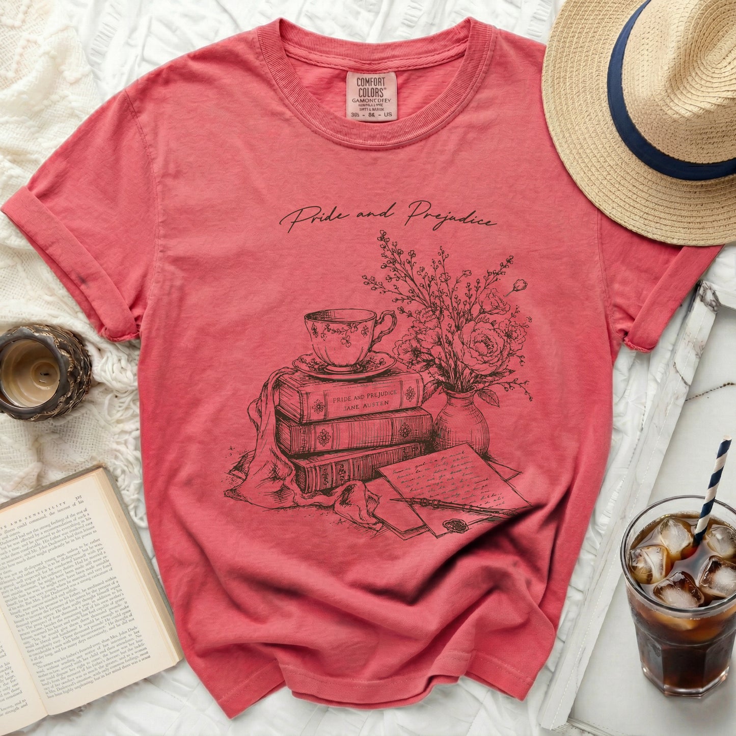 Pink t-shirt with "Pride and Prejudice" and stack of books illustration.
