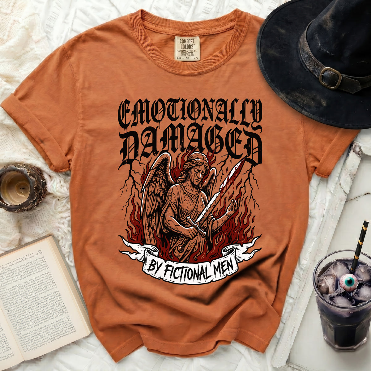 Orange t-shirt with "Emotionally Damaged by Fictional Men" graphic.