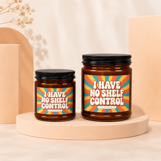 Two amber glass candles with black lids, featuring retro "I Have No Shelf Control" labels.