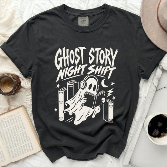 Dark gray Comfort Colors t-shirt with white ghost reading book graphic.