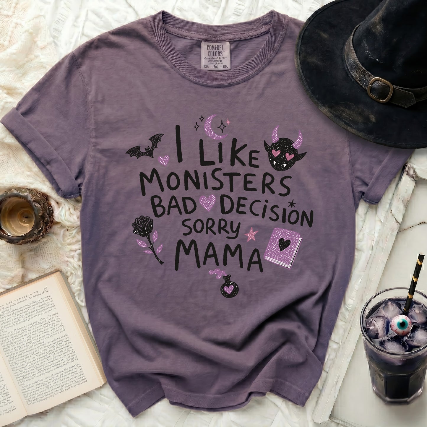 Purple t-shirt with "I like monsters, bad decision, sorry mama" text and Halloween graphics.