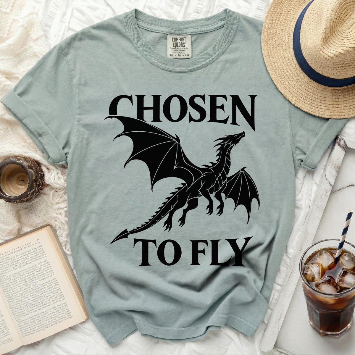 Light green t-shirt with black dragon graphic and text "CHOSEN TO FLY".