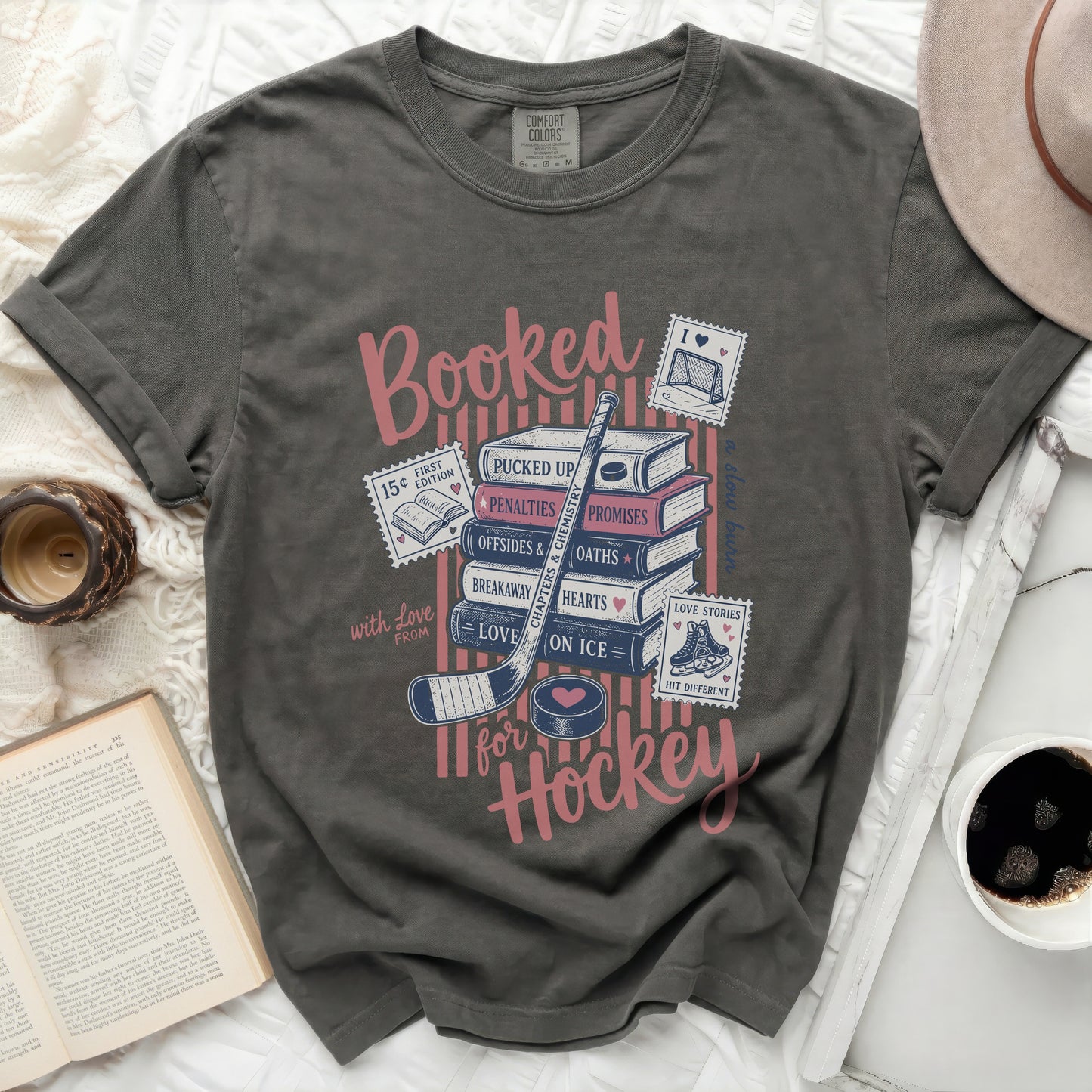 Gray t-shirt with "Booked for Hockey" in pink and blue text.
