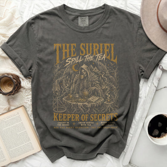 Dark grey t-shirt with "The Suriel Spill the Tea" and grim reaper design.