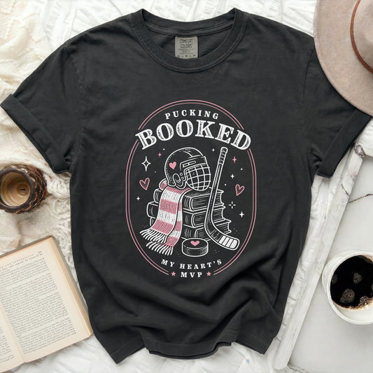 Black Comfort Colors t-shirt with pucking and hockey theme graphic.