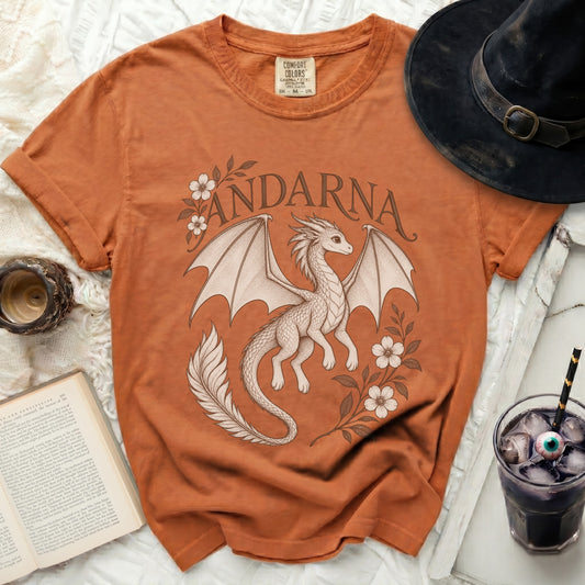 Rust-colored t-shirt featuring a vintage-style graphic of a dragon, floral vines, and the name Andarna.