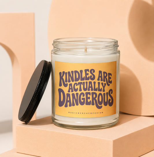 Glass candle with "Kindles are actually dangerous" text on a yellow label.
