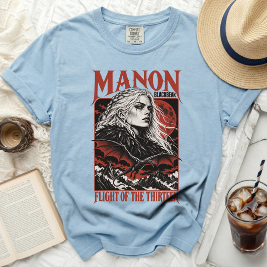 Light blue t-shirt with "Manon Blackbeak Flight of the Thirteen" graphic.