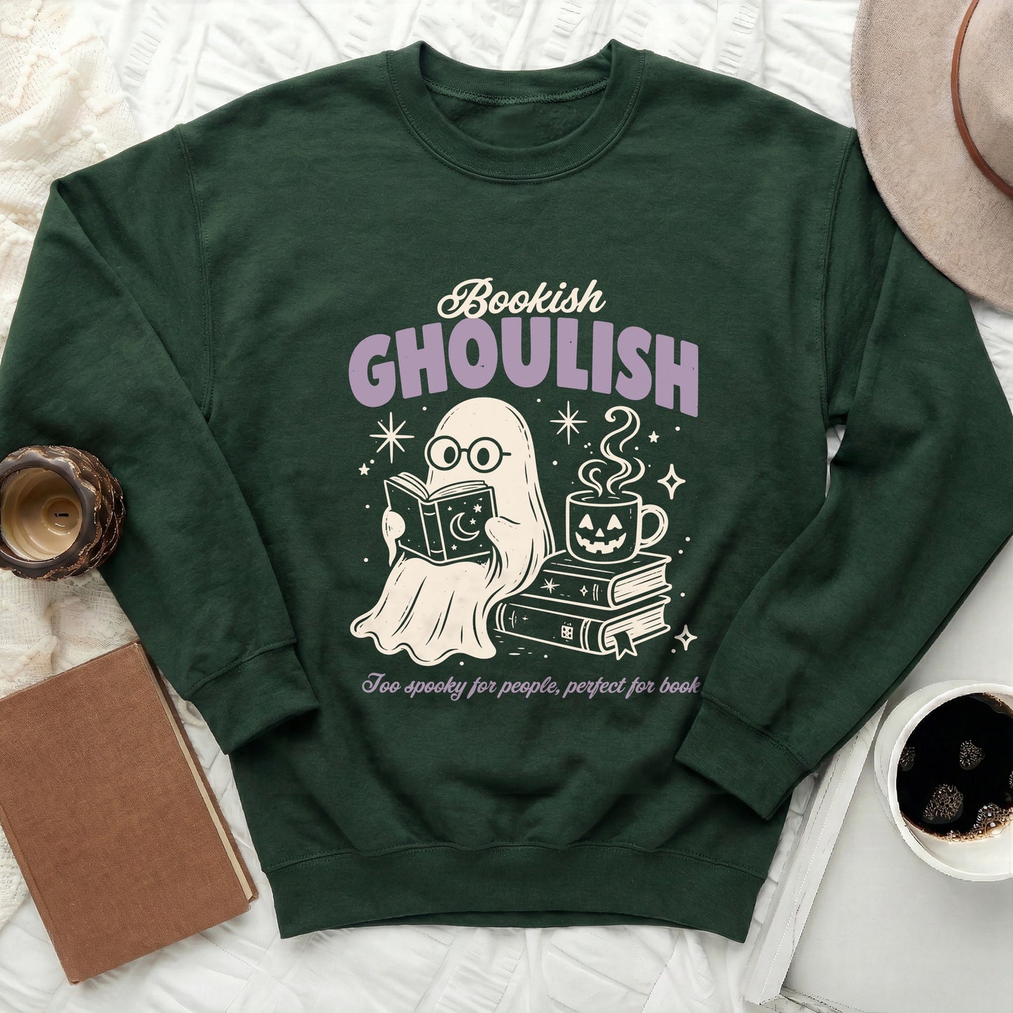 Green sweatshirt with ghost reading, drinking coffee, and books design.