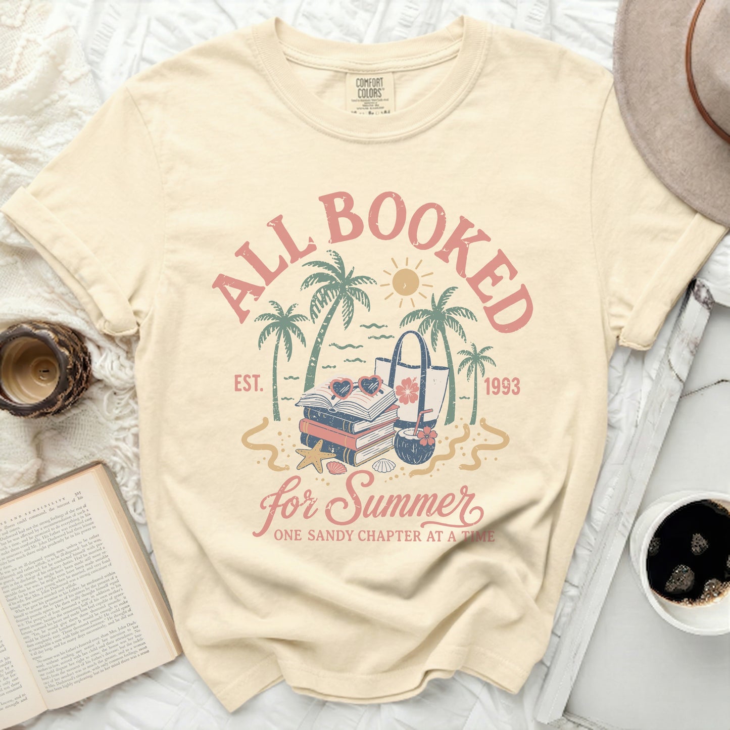 "All Booked for Summer" graphic tee with books and beach bag.