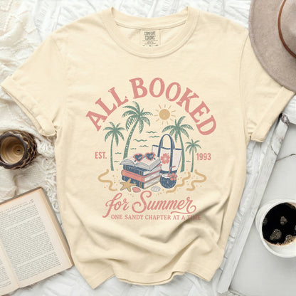 "All Booked for Summer" graphic tee with books and beach bag.