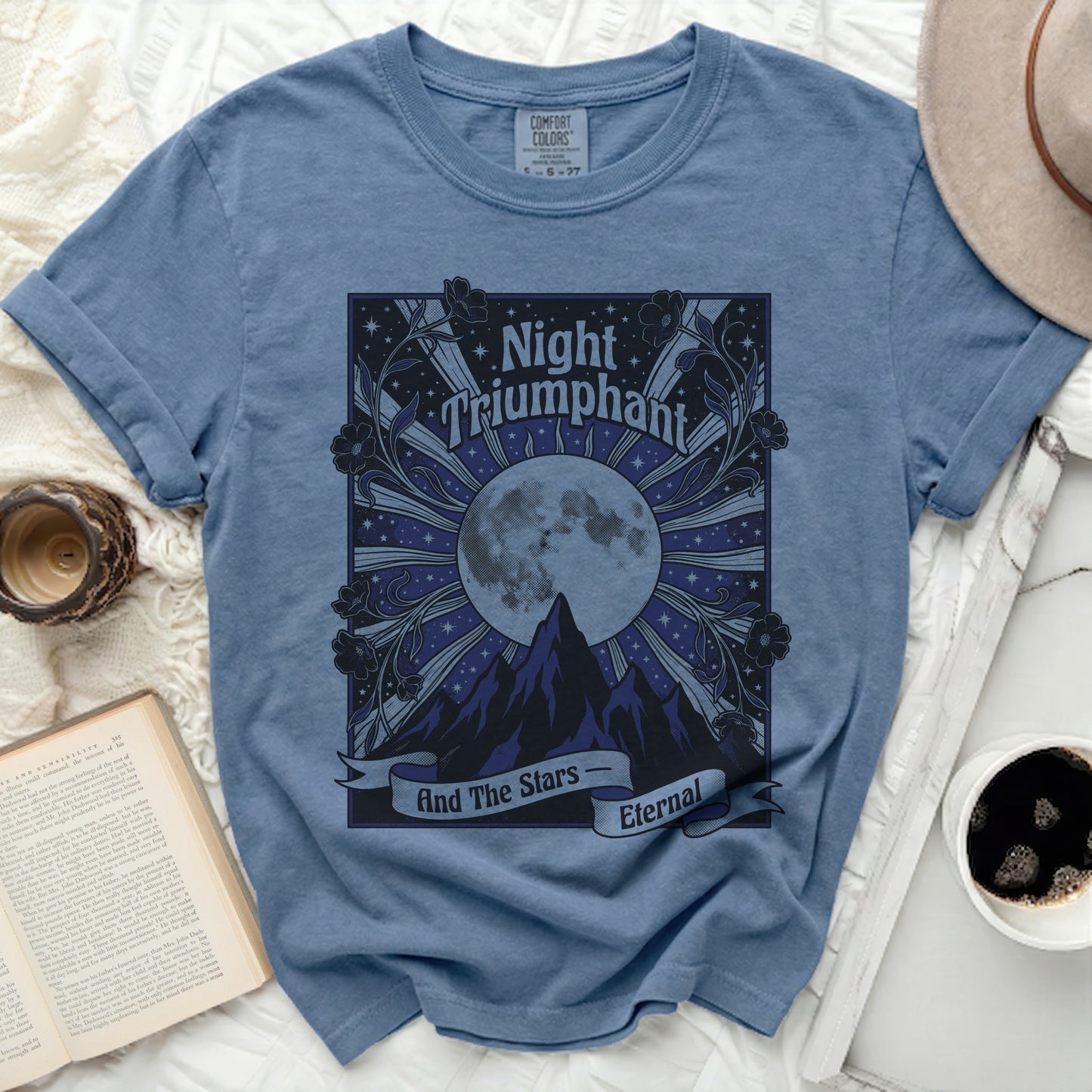 Blue t-shirt with "Night Triumphant And The Stars Eternal" graphic.