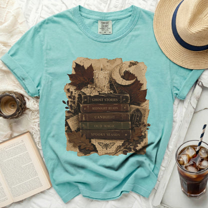 Teal t-shirt with vintage stack of books and gothic motifs print.