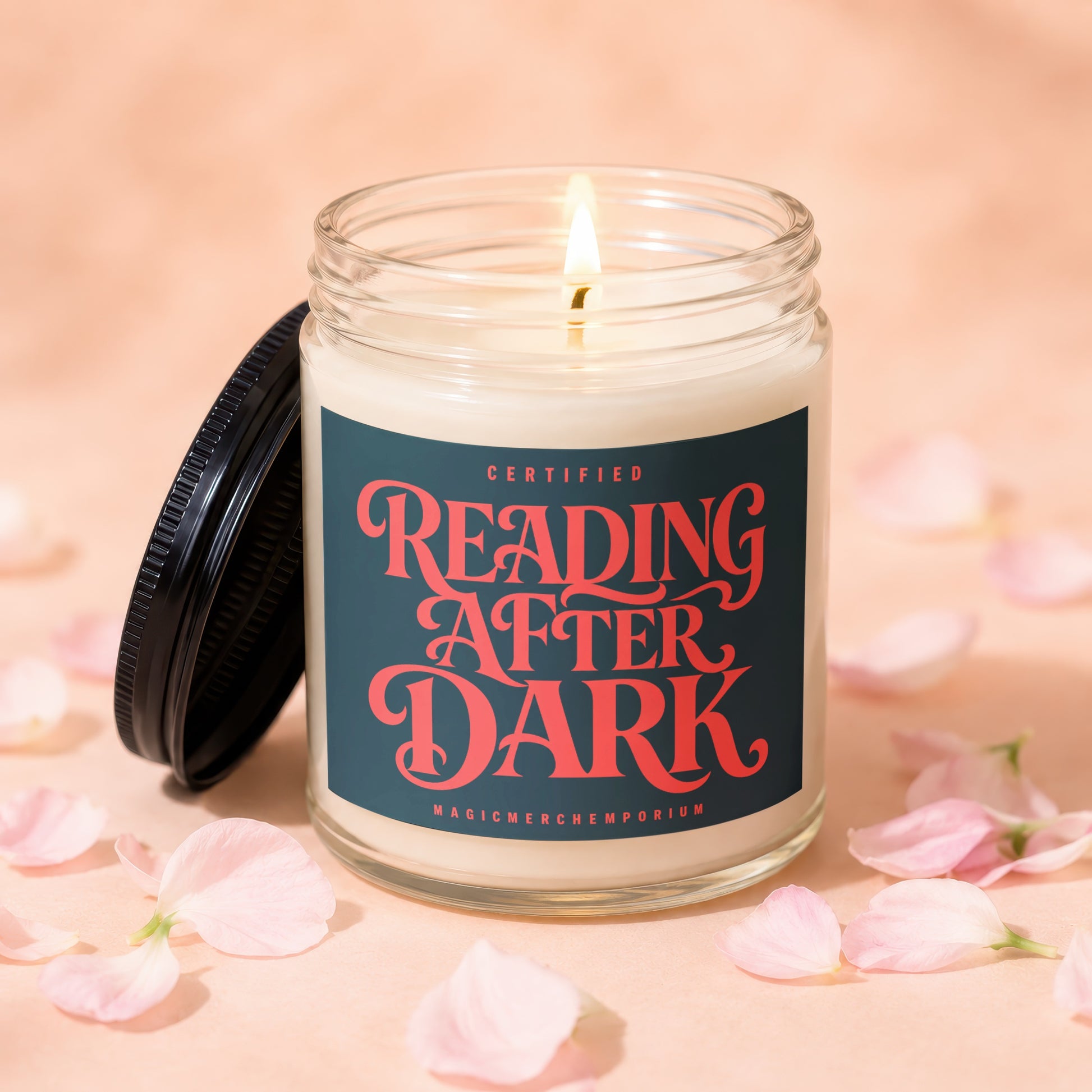 Jar candle with black lid, lit wick, and "Reading After Dark" label.