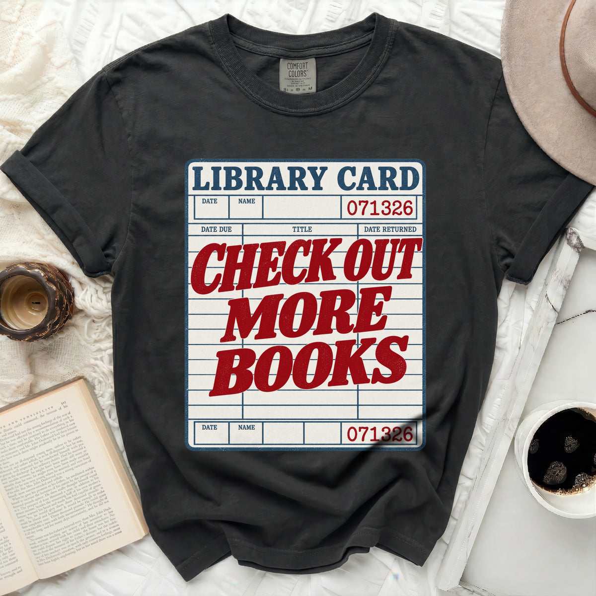 Black t-shirt with "Library Card" graphic reading "Check Out More Books".