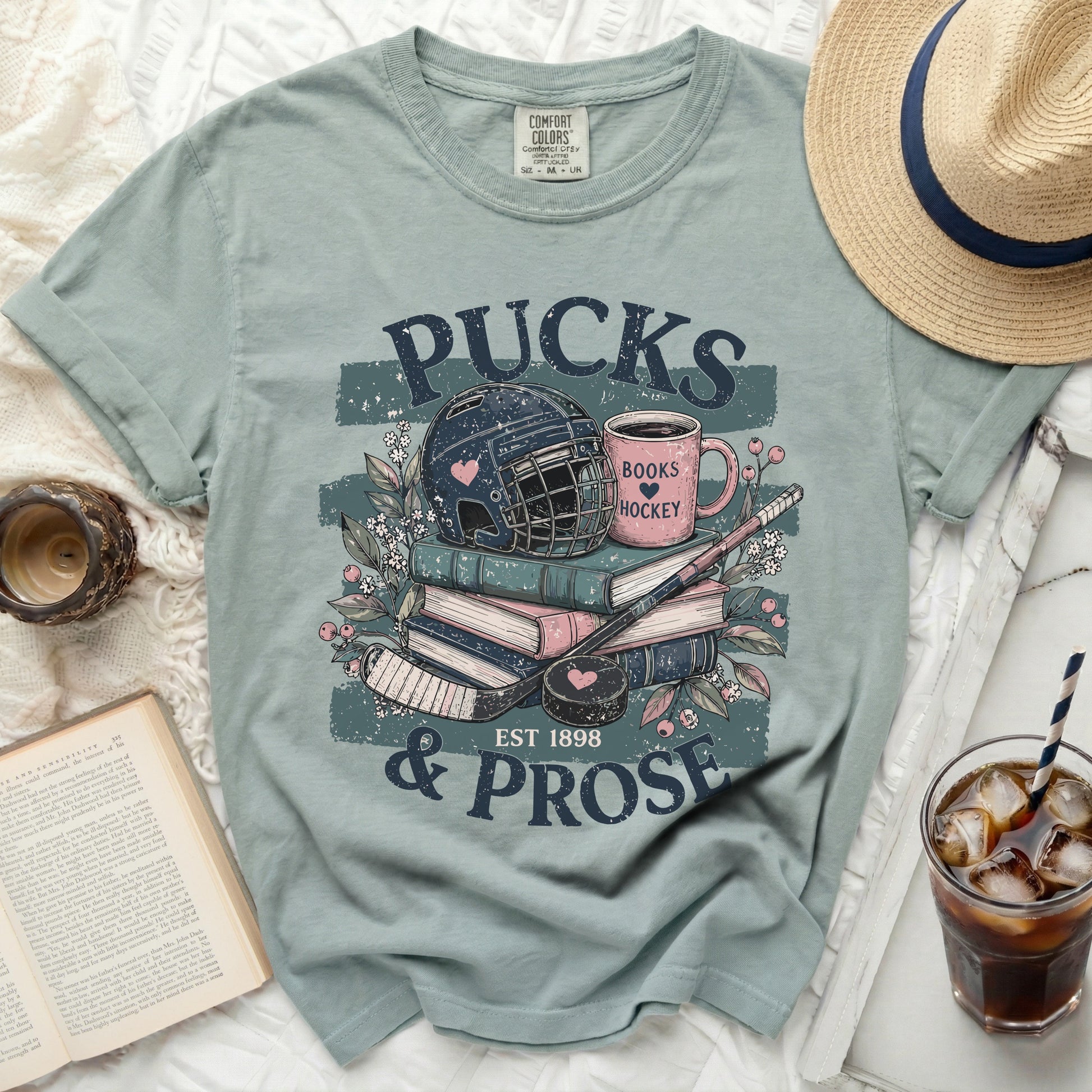 T-shirt with "Pucks & Prose" text, hockey gear, and books.