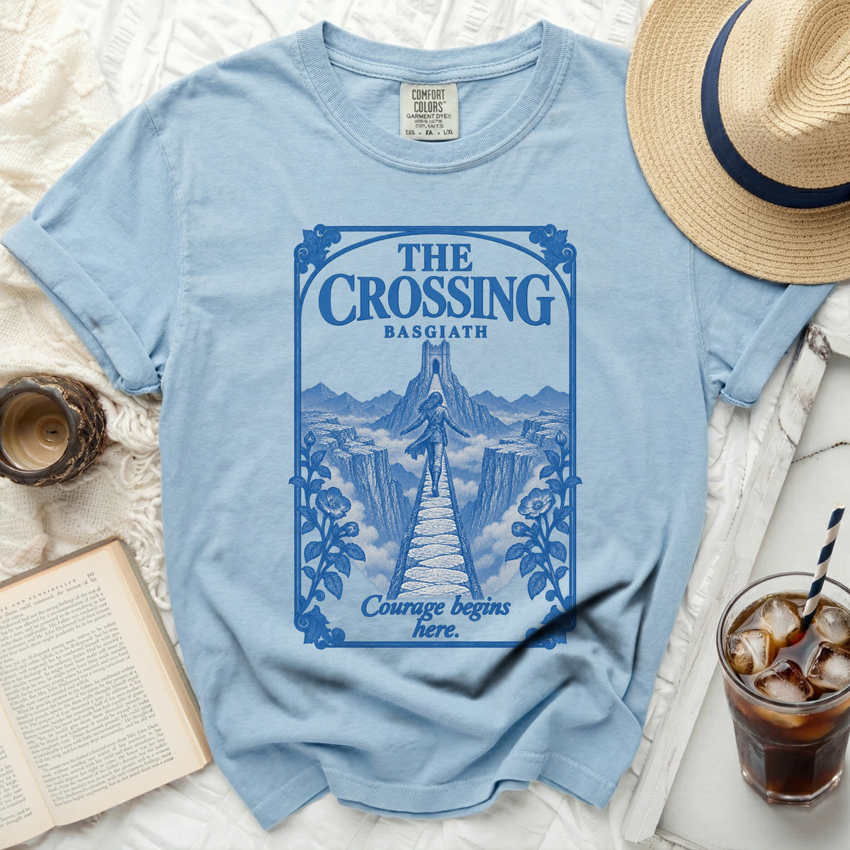 Light blue t-shirt with "The Crossing Basgiath" graphic and "Courage begins here" text.