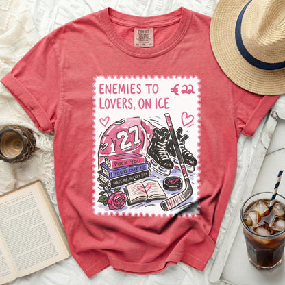 Pink t-shirt with ice hockey, skates, books, and text "LOVERS, ON ICE".
