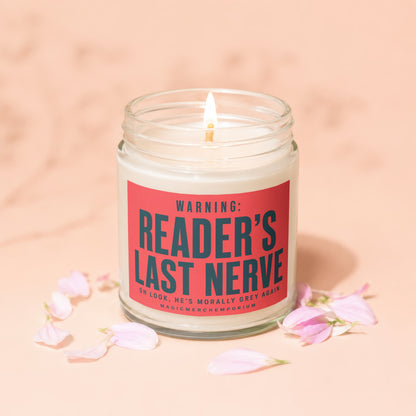 Jar candle with lit wick and red label reading "Reader's Last Nerve".