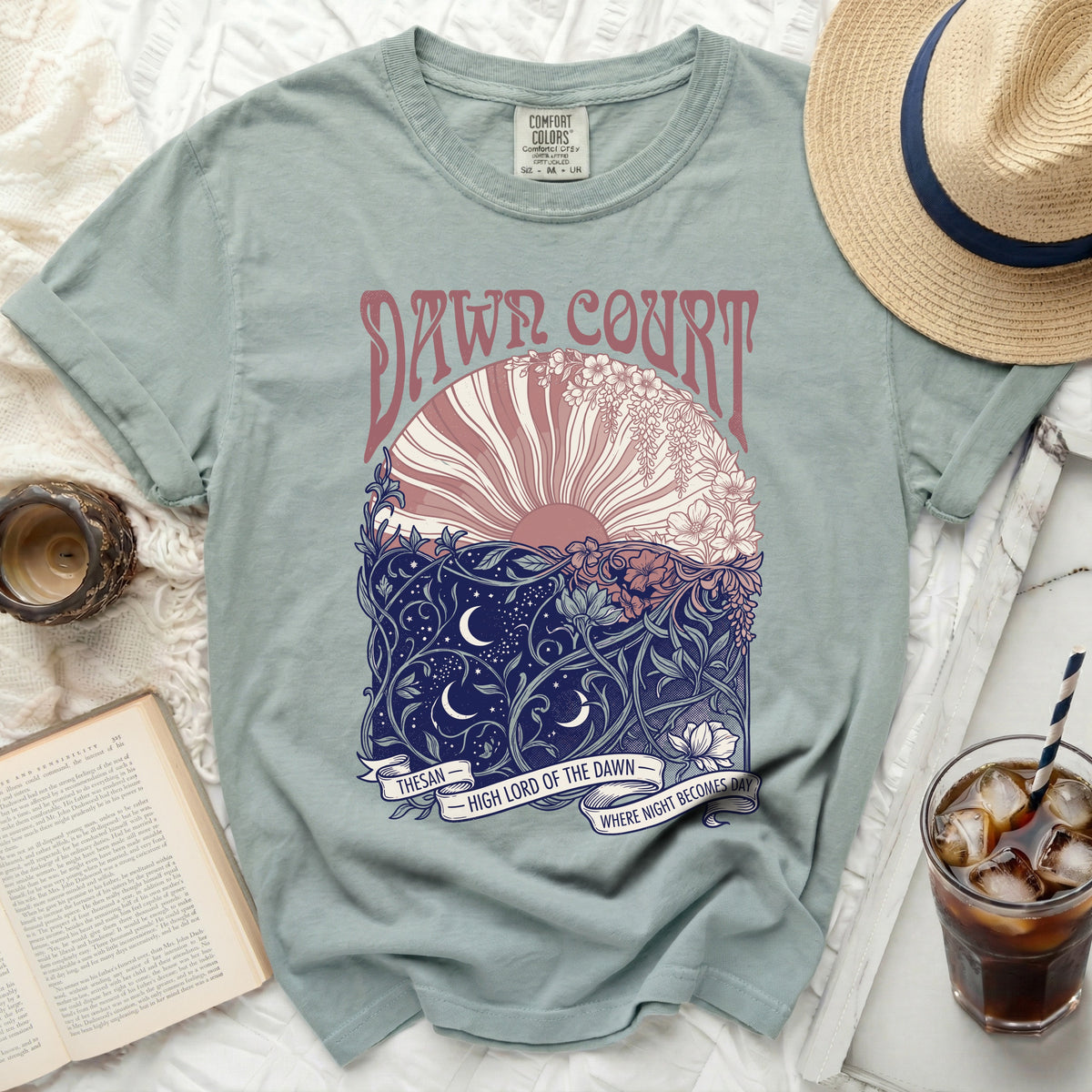 Green t-shirt with "Dawn Court" and floral sun/moon design.
