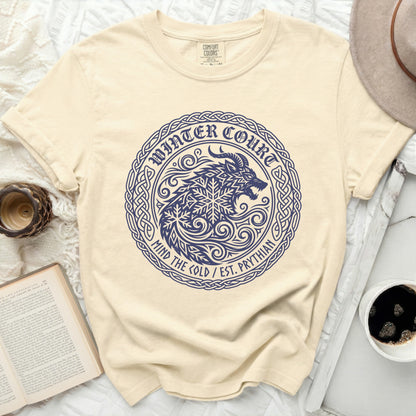 Cream t-shirt with a navy blue circle graphic of a wolf and snowflake.