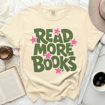 Cream t-shirt with "Read More Books" in green distressed lettering and pink stars.