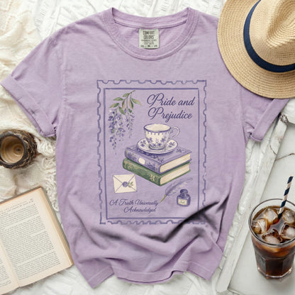 Purple t-shirt with "Pride and Prejudice" design featuring teacup, books, quill, and ink.