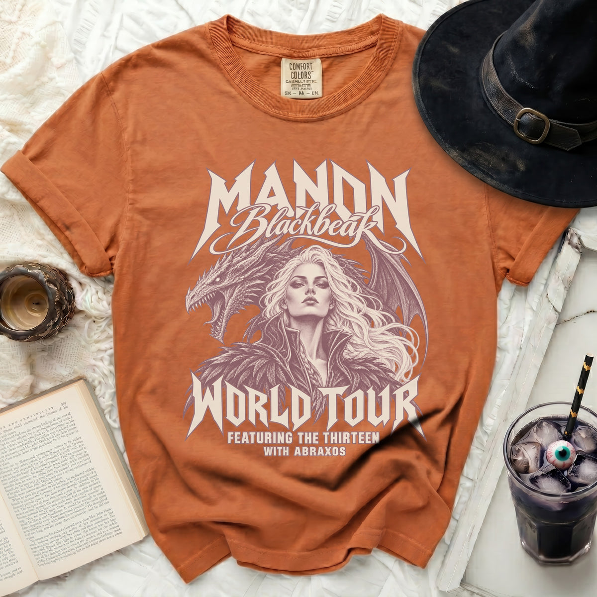 Orange t-shirt with Manon Blackbeak dragon and world tour graphic.