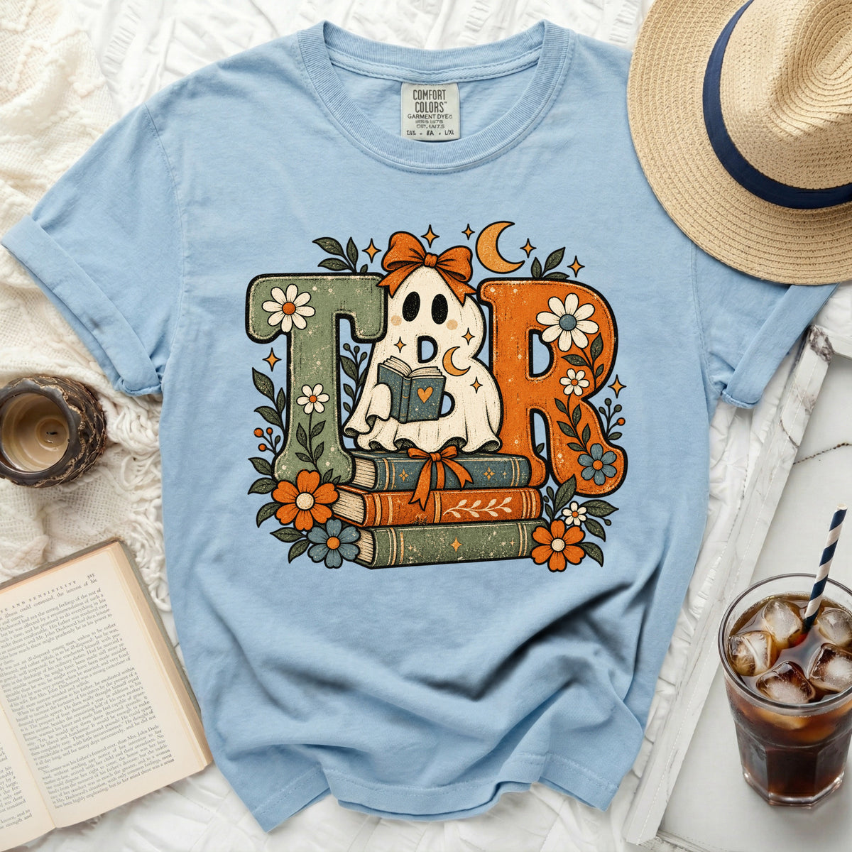 Ghost reading books TR design on light blue t-shirt.