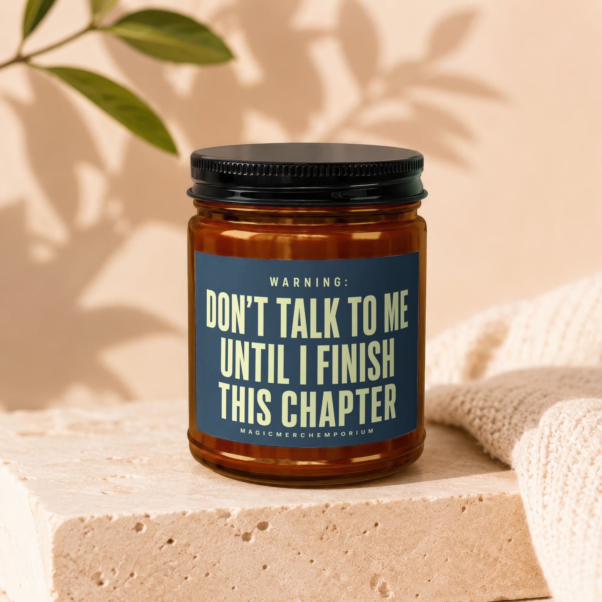 Amber jar candle with dark lid and "Don't talk to me until I finish this chapter" text.