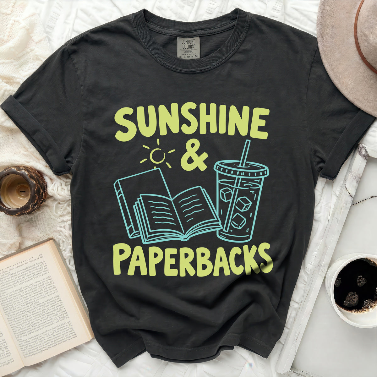 Dark gray Comfort Colors t-shirt with "Sunshine & Paperbacks" text design.