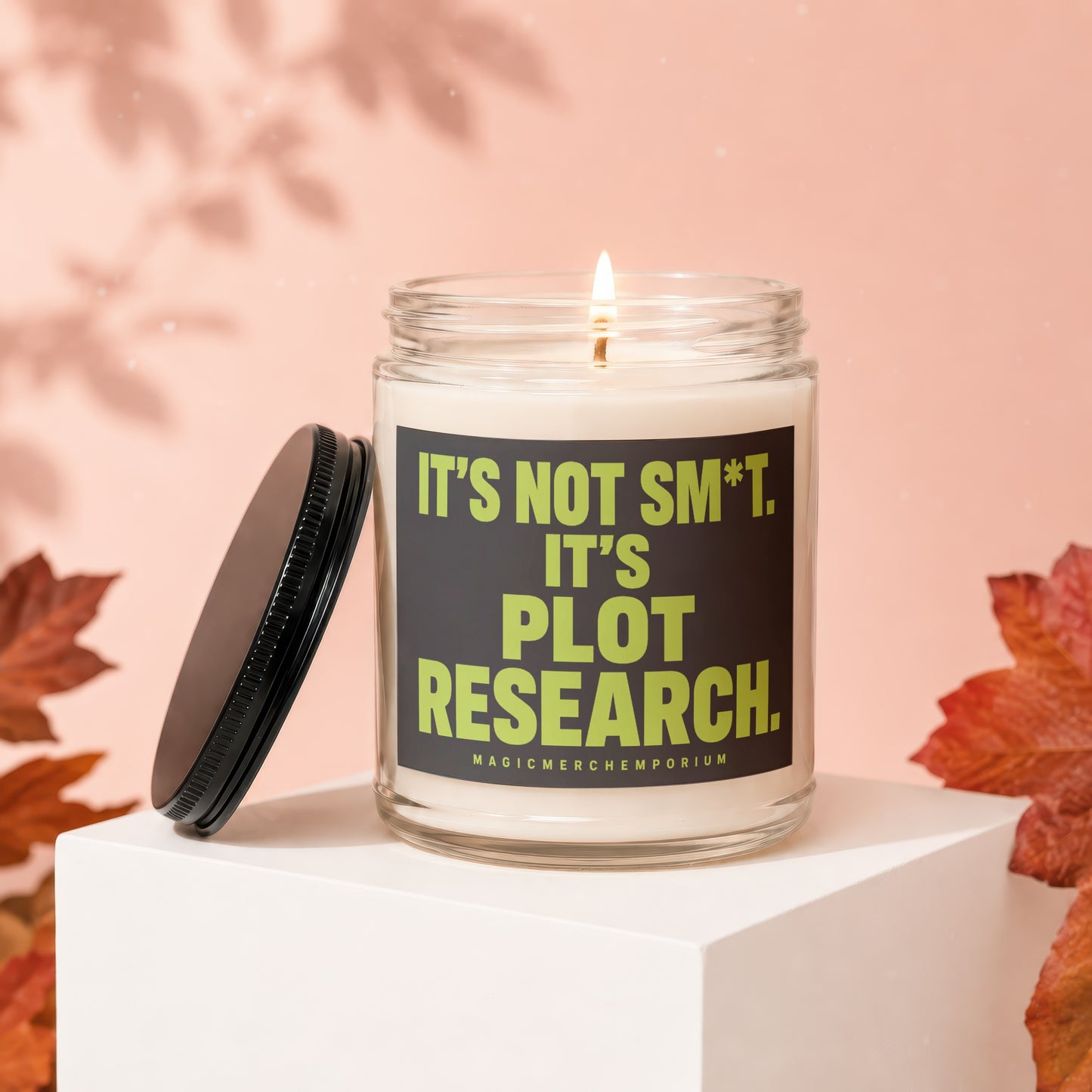 Lit candle in a jar with text "It's Not Sm*t. It's Plot Research."