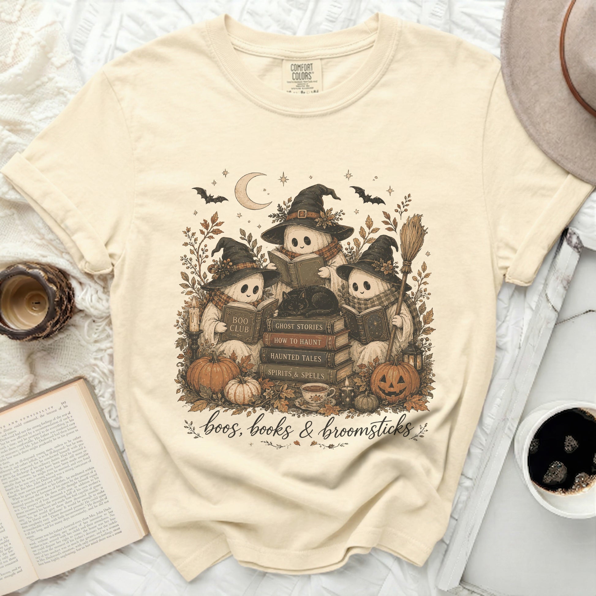 Three ghosts in witch hats read books on Halloween, text says "boos, books & broomsticks".