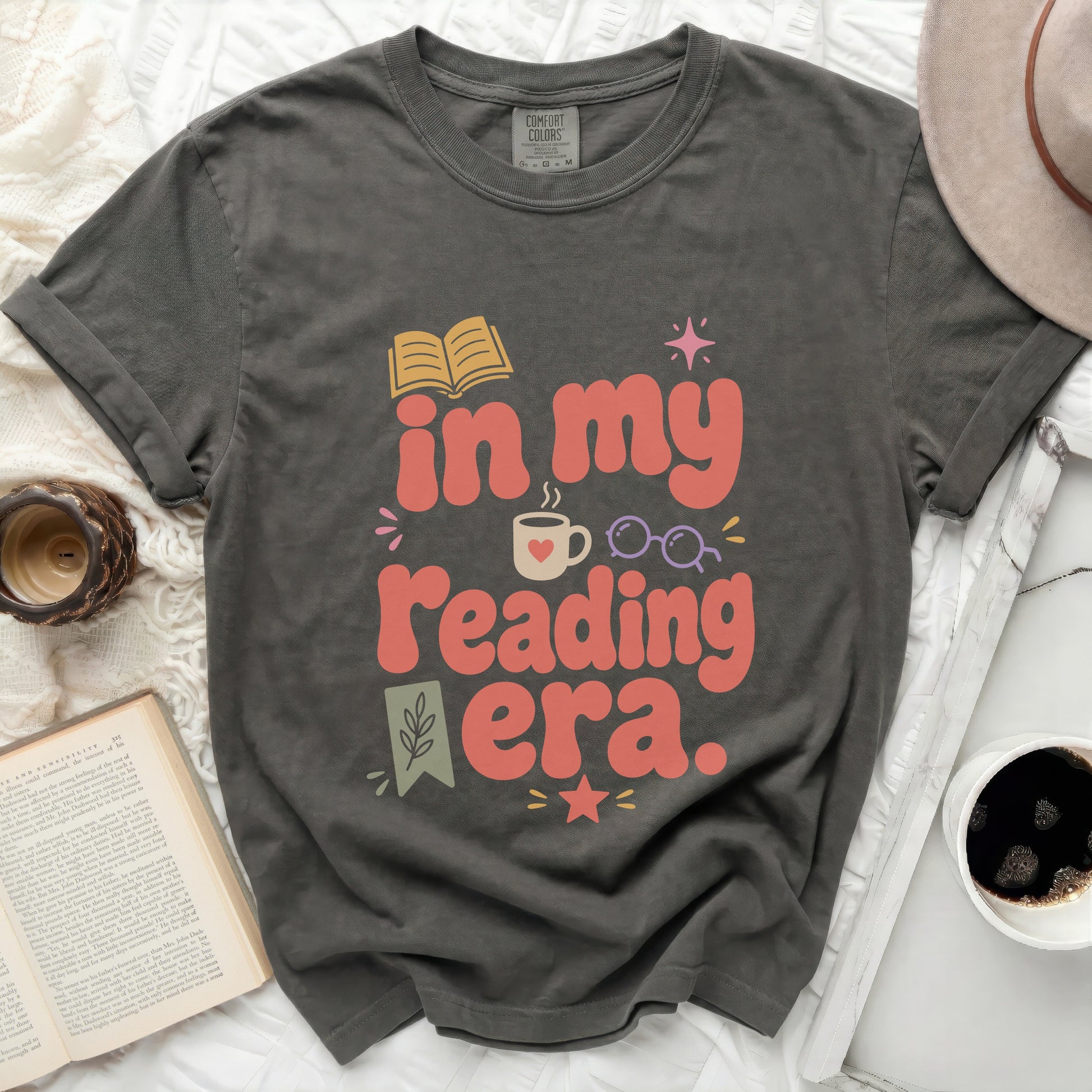 Graphic tee with "in my reading era." text and book graphic.