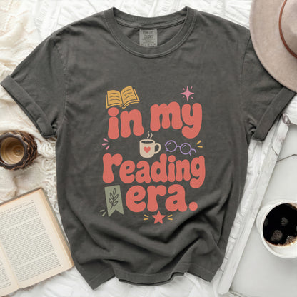 Graphic tee with "in my reading era." text and book graphic.