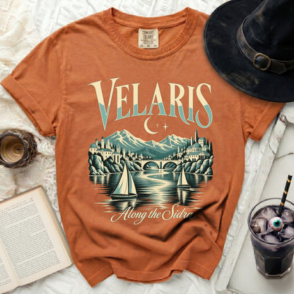Orange t-shirt with "Velaris Along the Sidra" text and a cityscape.