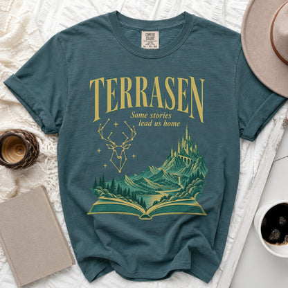 Teal t-shirt with "TERRASEN Some stories lead us home" and fantasy landscape.