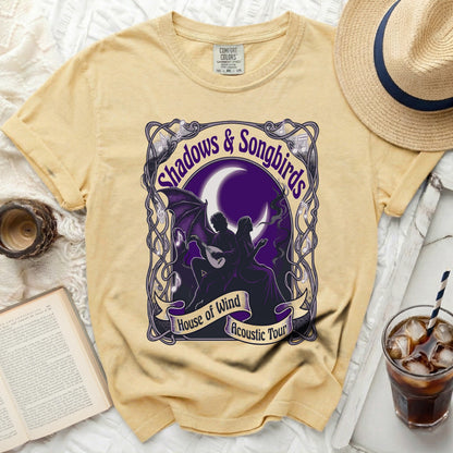 Yellow t-shirt with "Shadows & Songbirds House of Wind Acoustic Tour" graphic.