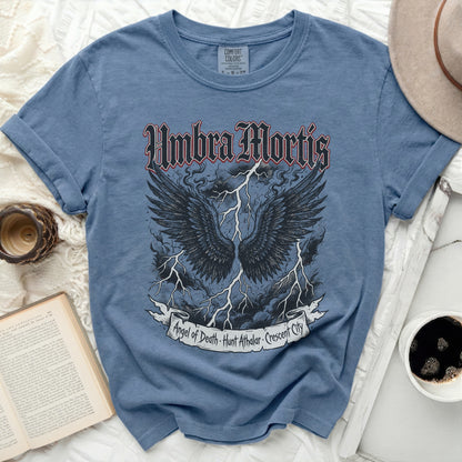 Blue t-shirt with "Umbra Mortis" and "Angel of Death" graphics.