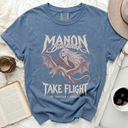 Blue shirt with "Manon Blackbeak Take Flight" and dragon graphic.