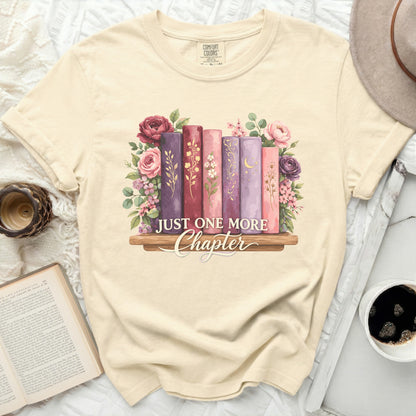 T-shirt with a floral bookshelf design and the text "Just One More Chapter".
