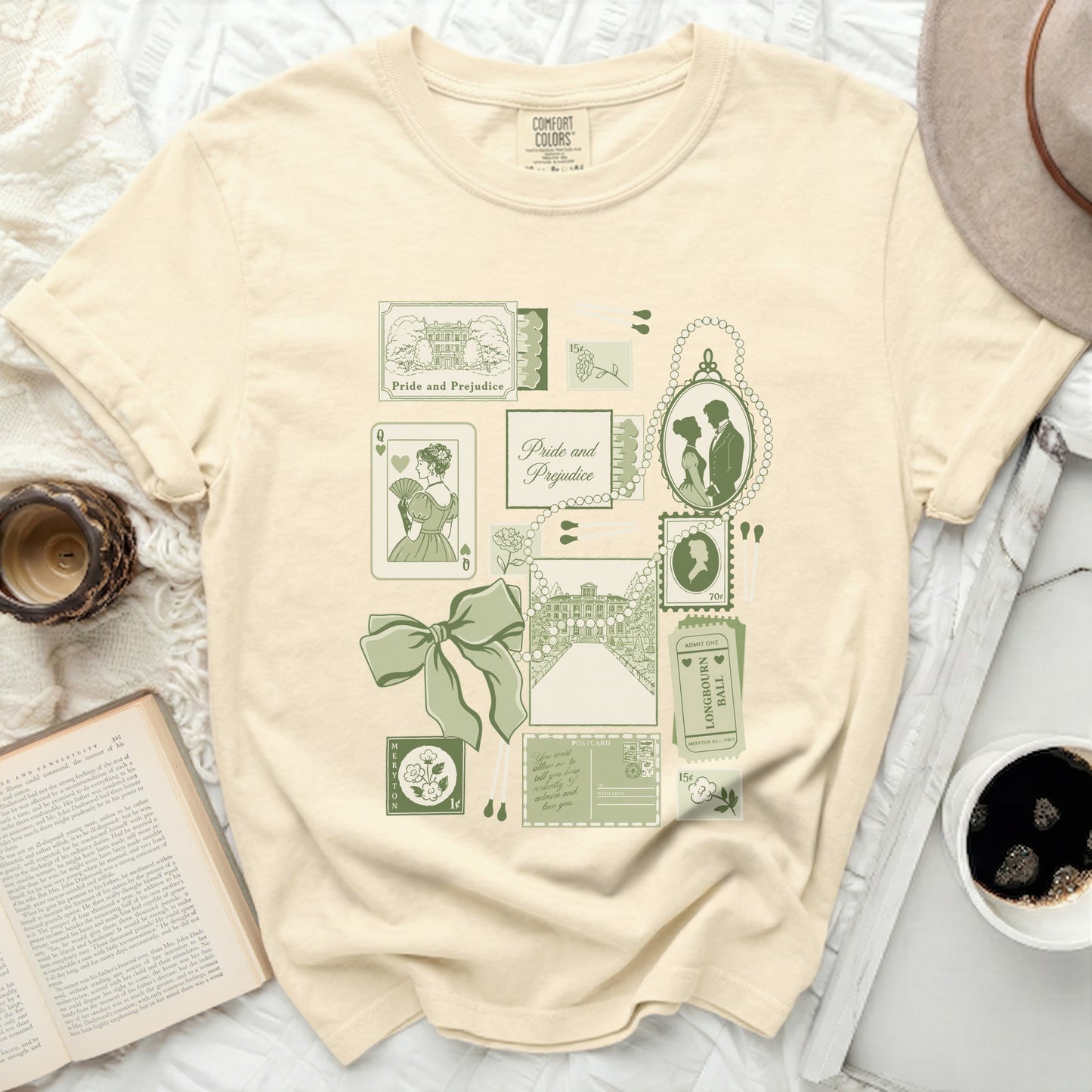 Cream t-shirt with "Pride and Prejudice" graphic featuring stamps, postcard, and silhouettes.