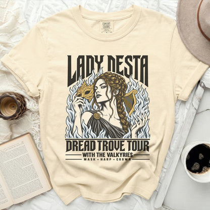 Cream t-shirt with "Lady Nesta Dread Trove Tour" graphic featuring a woman with a mask.