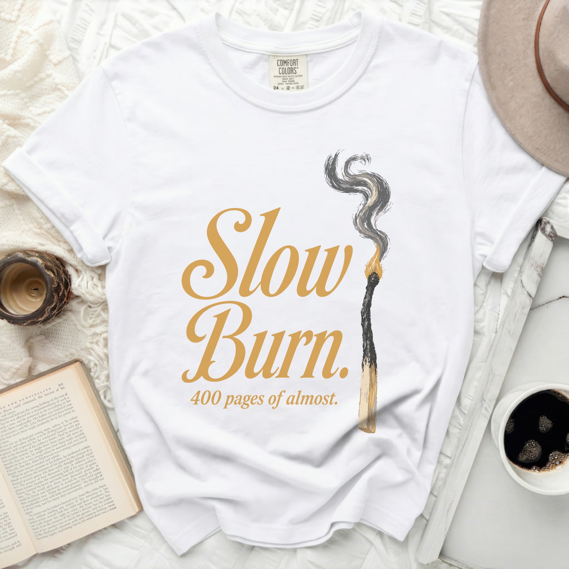 White t-shirt with "Slow Burn 400 pages of almost" graphic.