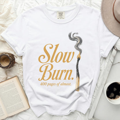 White t-shirt with "Slow Burn 400 pages of almost" graphic.