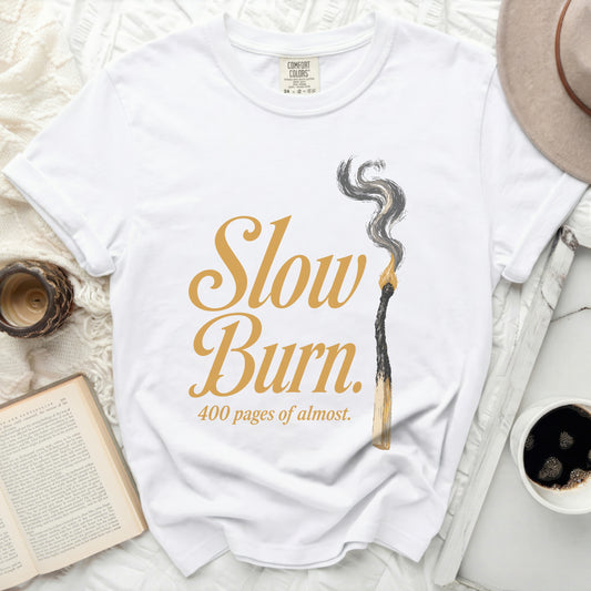 White t-shirt with "Slow Burn 400 pages of almost" graphic.