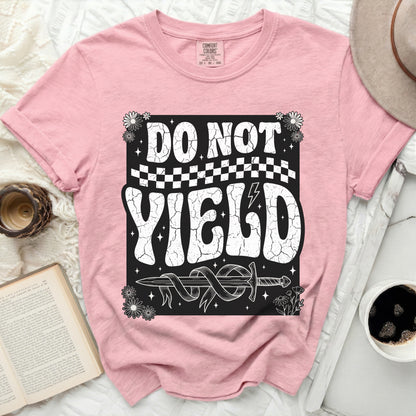 Pink t-shirt with "DO NOT YIELD" text, a sword, and floral graphics.